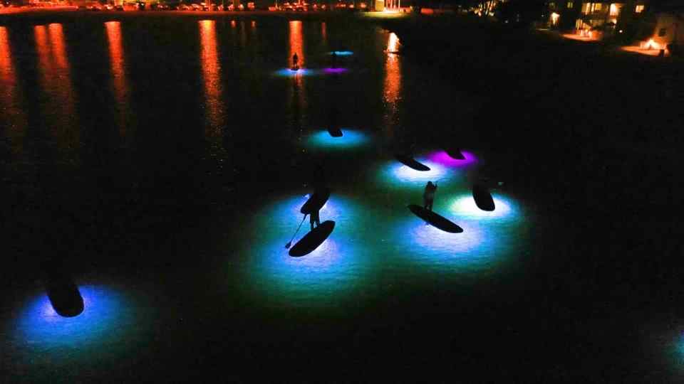 Glow paddleboards on Mission Bay at night