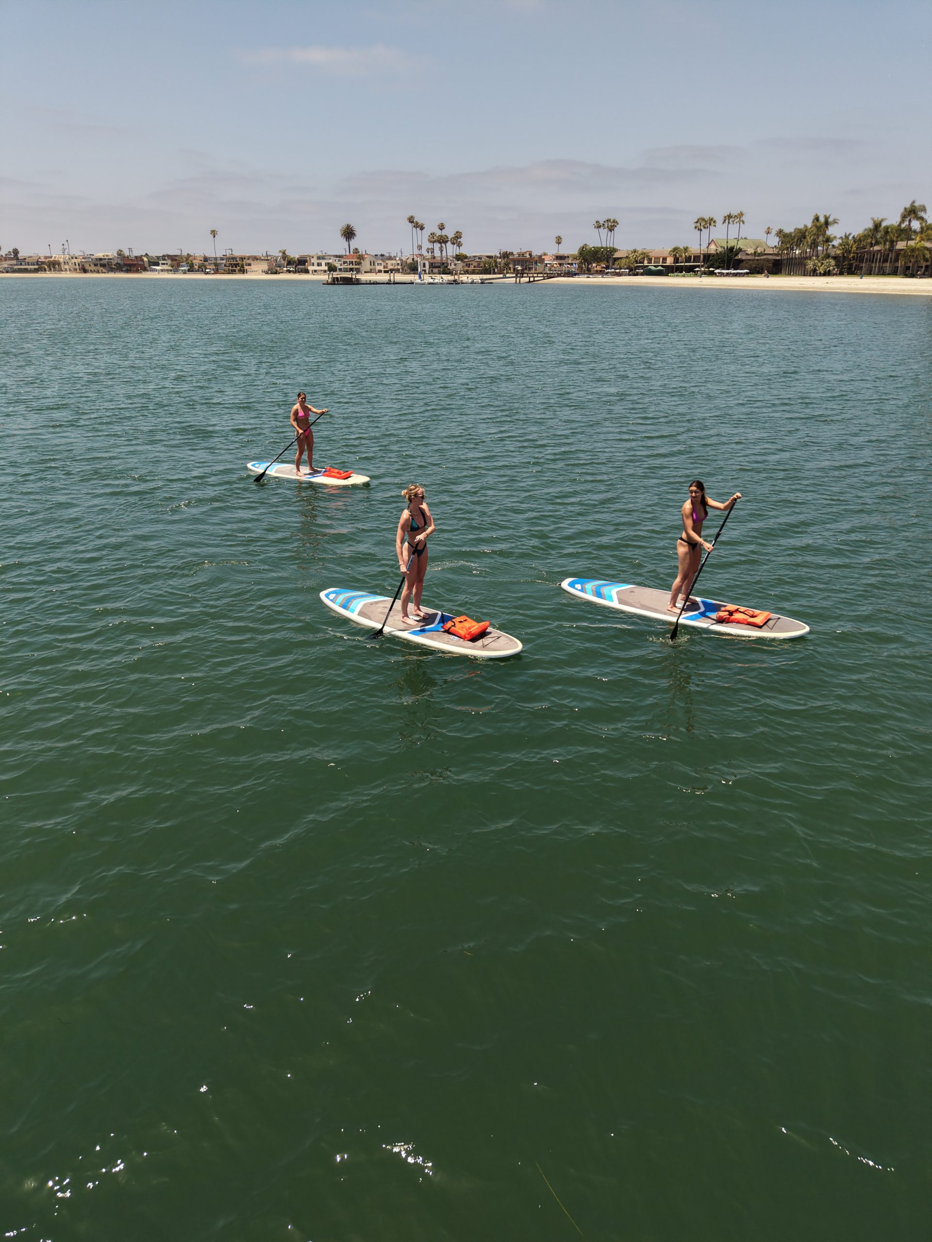 Paddleboards on the water during responsible recreation on Mission Bay