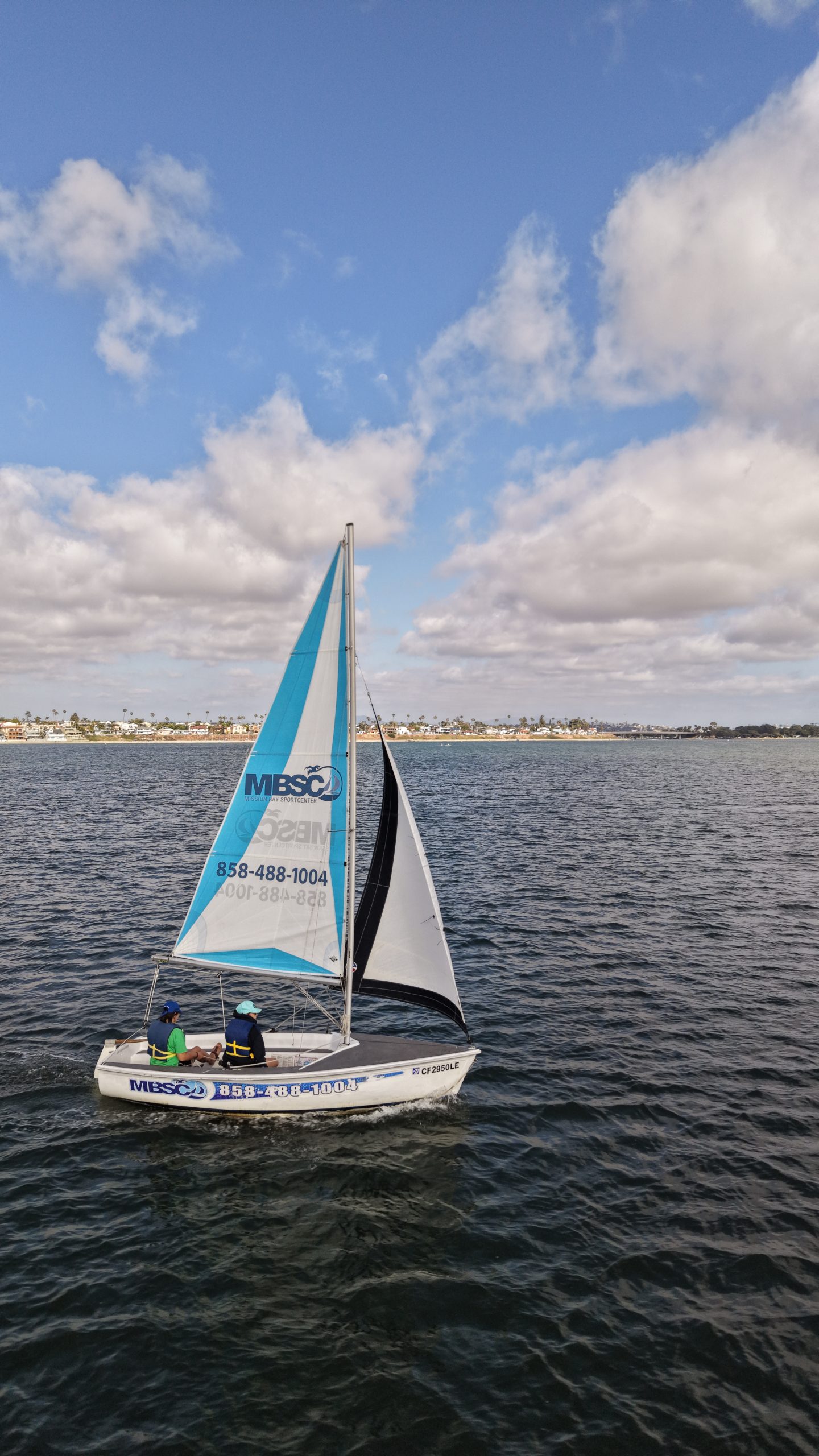 Catalina 14.2 sailboat on the blue water of Mission Bay