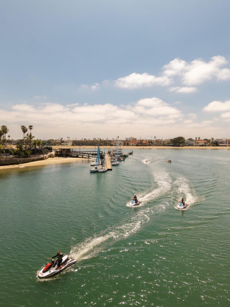 Jet Ski riders moving across Mission Bay