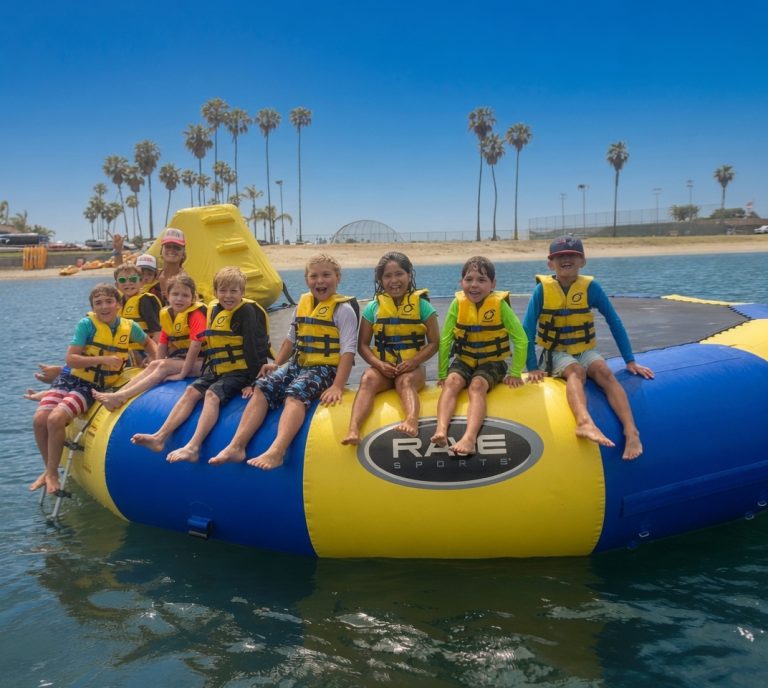 Group enjoying a floating water trampoline on Mission Bay